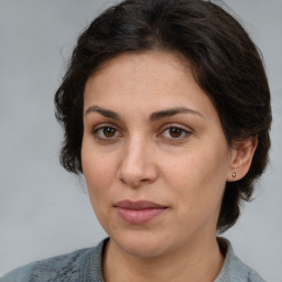 Joyful white adult female with medium  brown hair and brown eyes