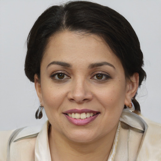 Joyful latino young-adult female with medium  brown hair and brown eyes