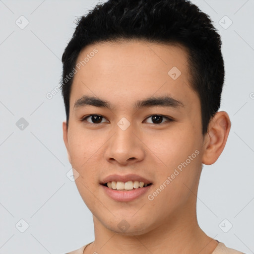 Joyful asian young-adult male with short  black hair and brown eyes