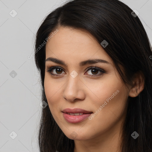 Joyful latino young-adult female with long  brown hair and brown eyes