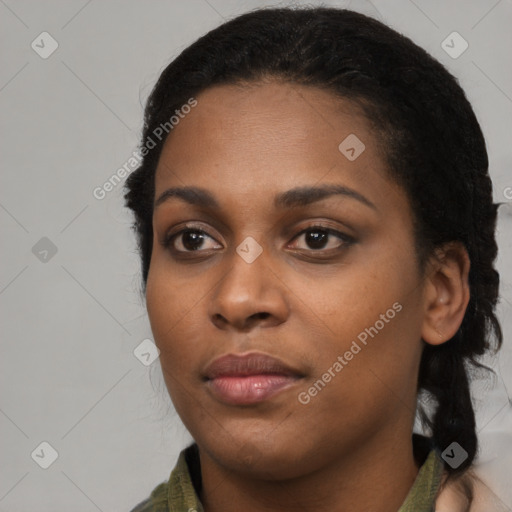 Joyful black young-adult female with long  black hair and brown eyes