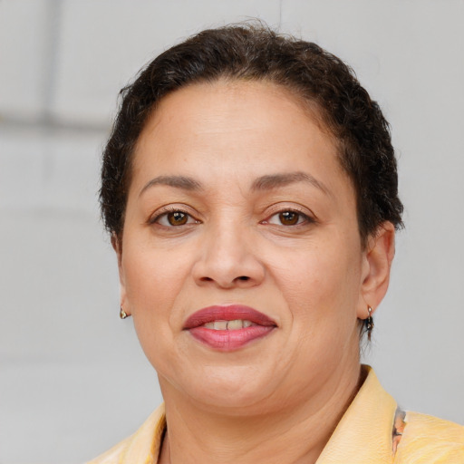 Joyful latino adult female with short  brown hair and brown eyes