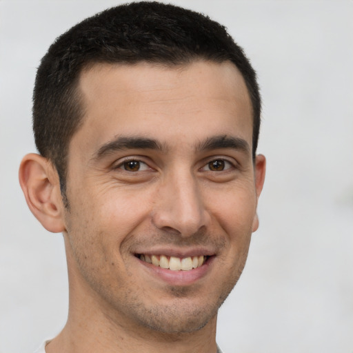 Joyful white young-adult male with short  brown hair and brown eyes