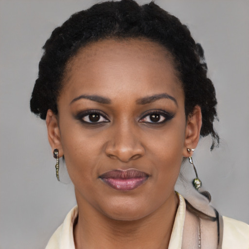 Joyful black young-adult female with short  brown hair and brown eyes