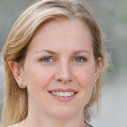 Joyful white young-adult female with medium  brown hair and blue eyes