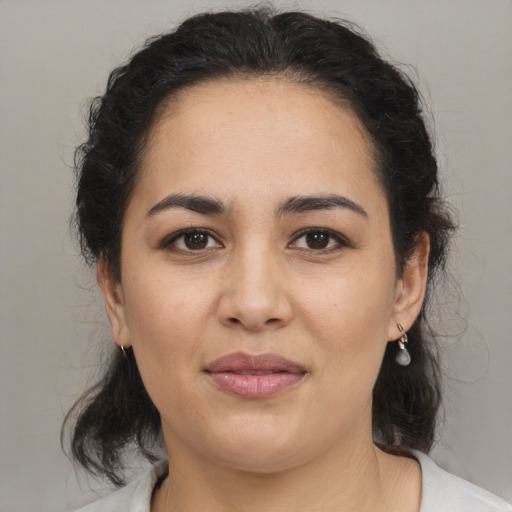 Joyful latino young-adult female with medium  black hair and brown eyes