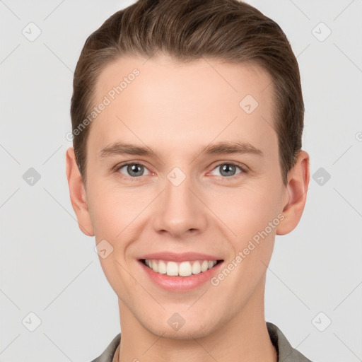 Joyful white young-adult male with short  brown hair and grey eyes