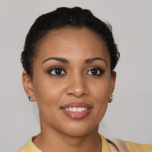 Joyful black young-adult female with short  brown hair and brown eyes