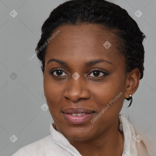 Joyful black young-adult female with short  black hair and brown eyes