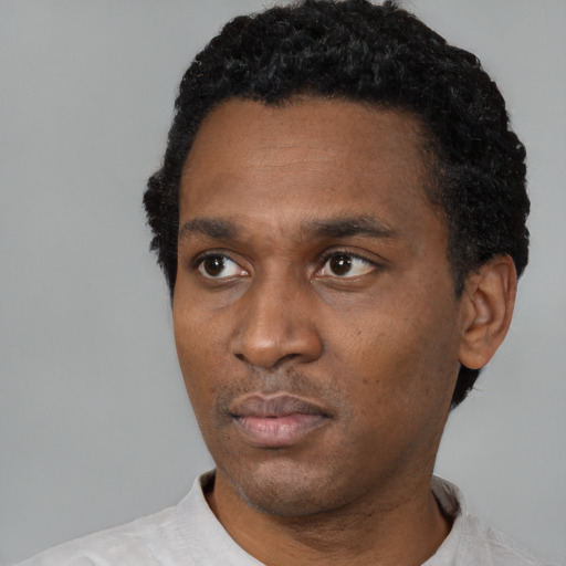 Neutral latino adult male with short  black hair and brown eyes
