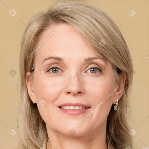 Joyful white adult female with medium  brown hair and blue eyes