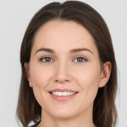 Joyful white young-adult female with long  brown hair and grey eyes