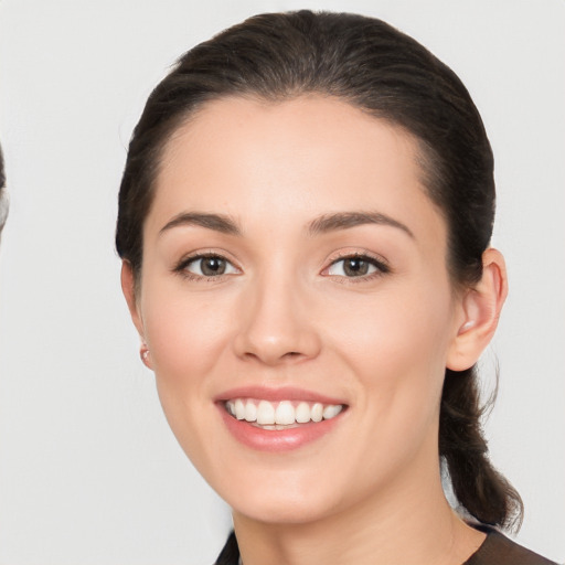 Joyful white young-adult female with medium  brown hair and brown eyes