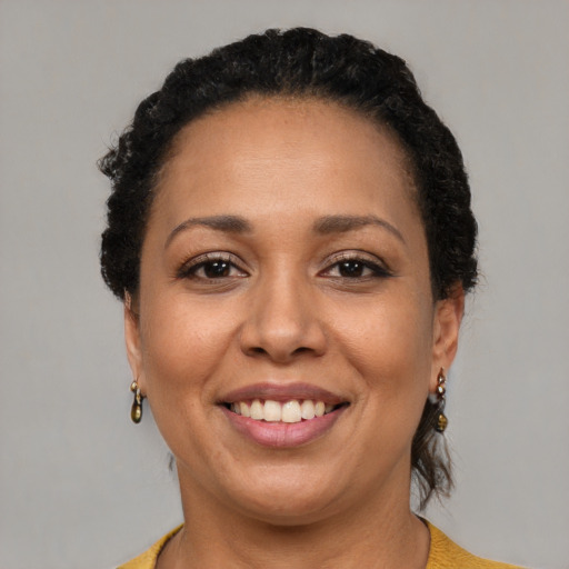 Joyful latino adult female with short  brown hair and brown eyes