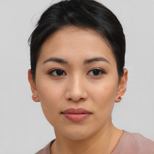 Joyful asian young-adult female with short  brown hair and brown eyes