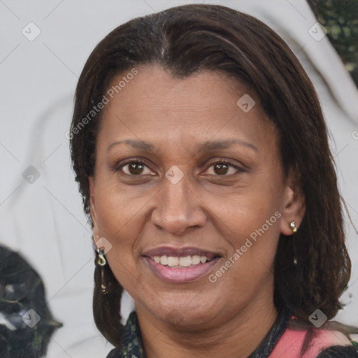 Joyful latino adult female with medium  brown hair and brown eyes