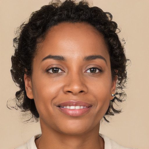 Joyful black young-adult female with medium  brown hair and brown eyes