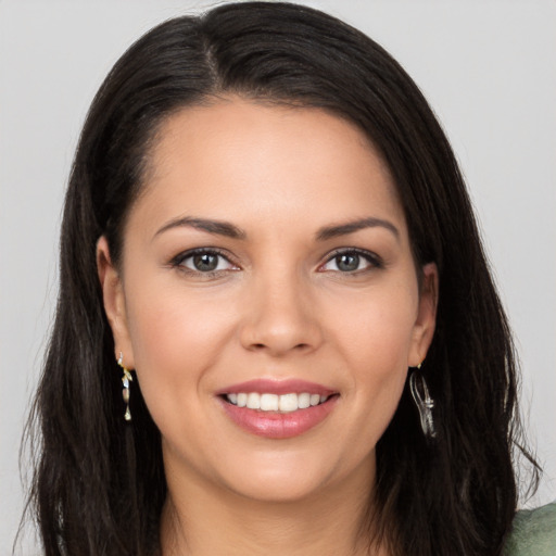 Joyful white young-adult female with long  brown hair and brown eyes