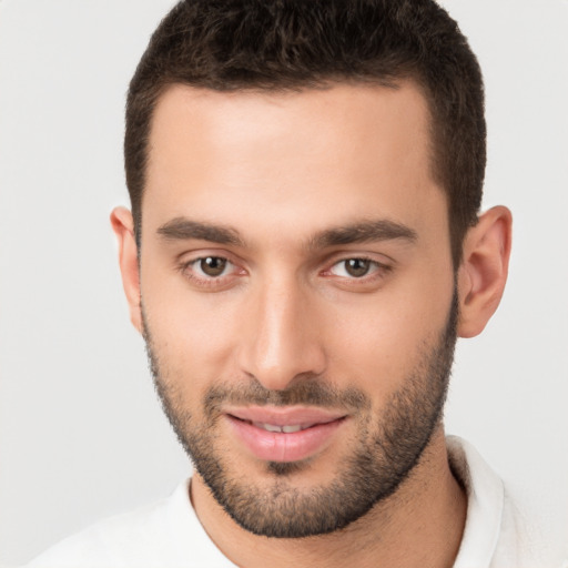 Joyful white young-adult male with short  brown hair and brown eyes