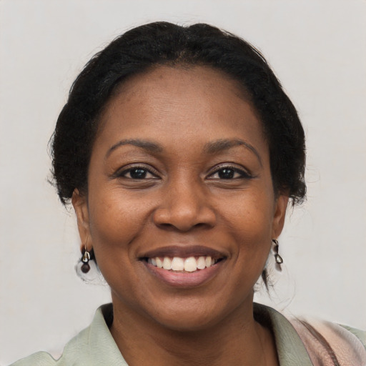 Joyful black young-adult female with medium  black hair and brown eyes