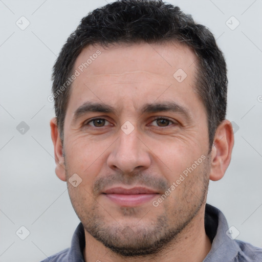 Joyful white adult male with short  brown hair and brown eyes