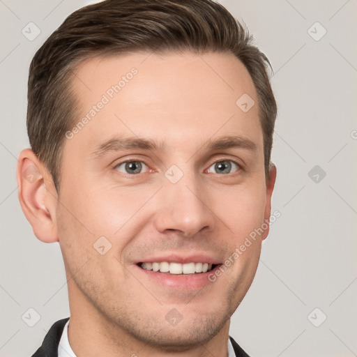 Joyful white young-adult male with short  brown hair and grey eyes