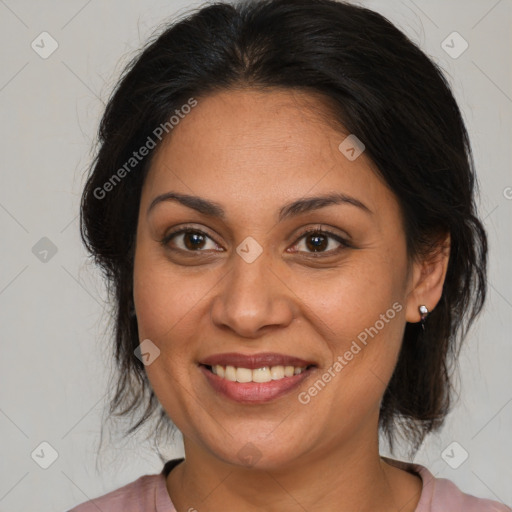 Joyful latino adult female with medium  brown hair and brown eyes