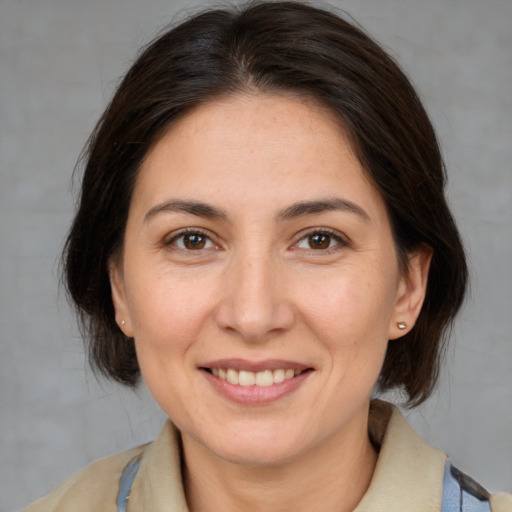 Joyful white adult female with medium  brown hair and brown eyes