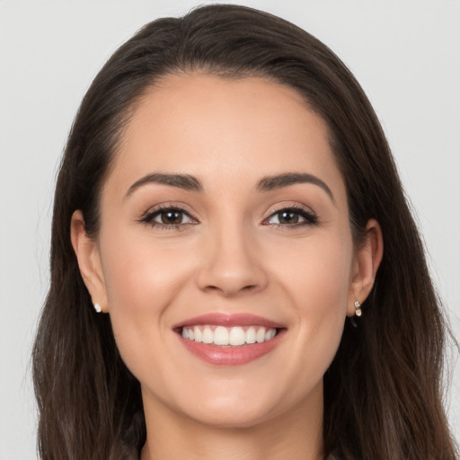 Joyful white young-adult female with long  brown hair and brown eyes