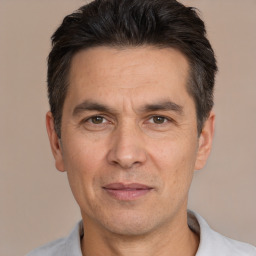 Joyful white adult male with short  black hair and brown eyes