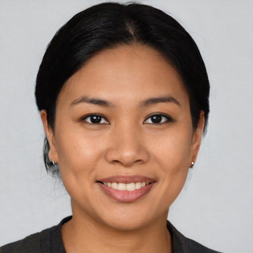 Joyful asian young-adult female with medium  black hair and brown eyes
