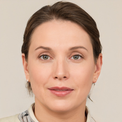 Joyful white adult female with short  brown hair and grey eyes