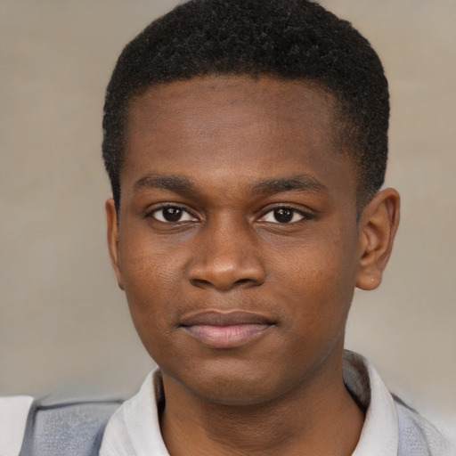 Joyful black young-adult male with short  brown hair and brown eyes