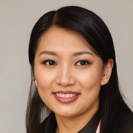 Joyful asian young-adult female with long  black hair and brown eyes
