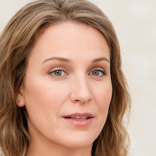 Joyful white young-adult female with long  brown hair and blue eyes