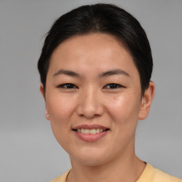 Joyful asian young-adult female with short  brown hair and brown eyes