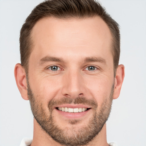 Joyful white young-adult male with short  brown hair and brown eyes