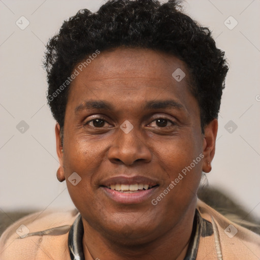 Joyful black adult male with short  brown hair and brown eyes