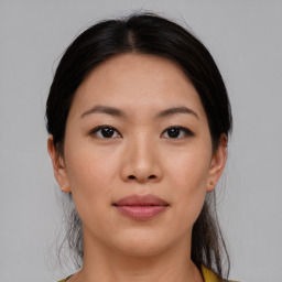 Joyful asian young-adult female with medium  black hair and brown eyes