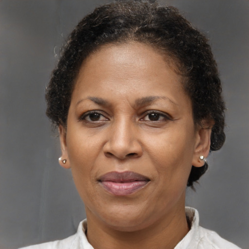Joyful black adult female with short  brown hair and brown eyes