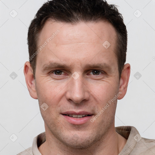 Joyful white adult male with short  brown hair and grey eyes