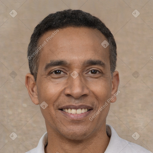 Joyful latino adult male with short  black hair and brown eyes