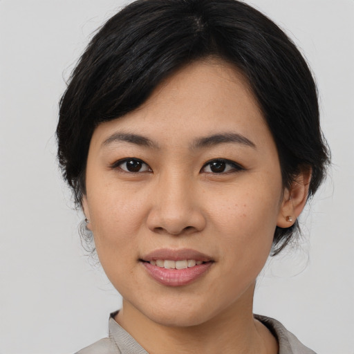 Joyful asian young-adult female with medium  black hair and brown eyes