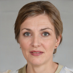 Joyful white adult female with medium  brown hair and grey eyes