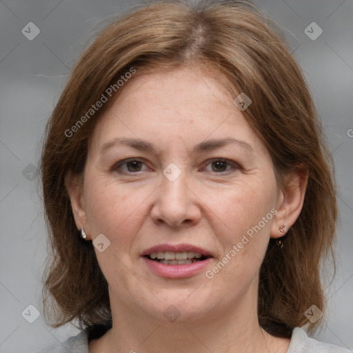 Joyful white adult female with medium  brown hair and brown eyes