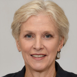 Joyful white middle-aged female with medium  brown hair and grey eyes