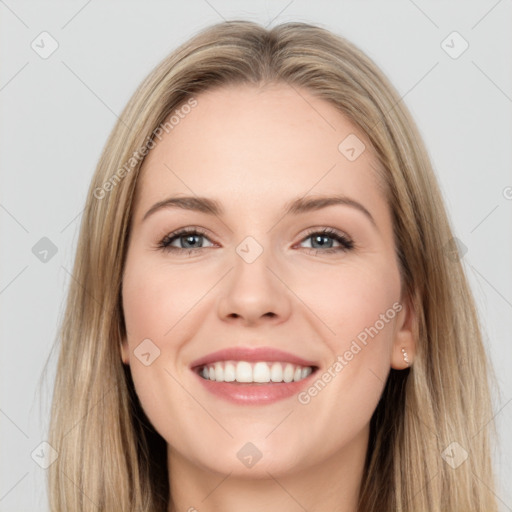 Joyful white young-adult female with long  brown hair and grey eyes