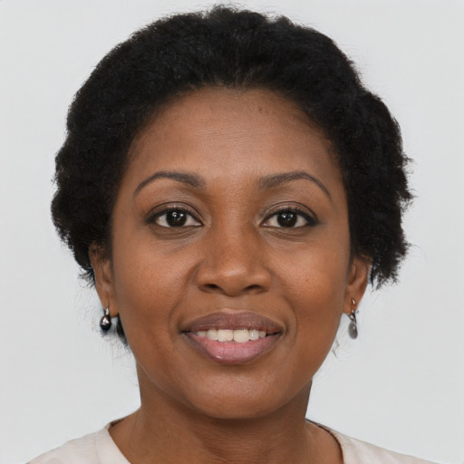 Joyful black adult female with short  brown hair and brown eyes