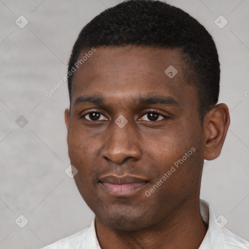 Joyful black young-adult male with short  black hair and brown eyes