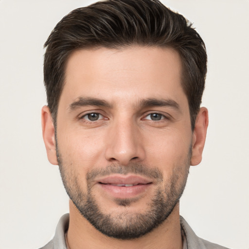 Joyful white young-adult male with short  brown hair and brown eyes